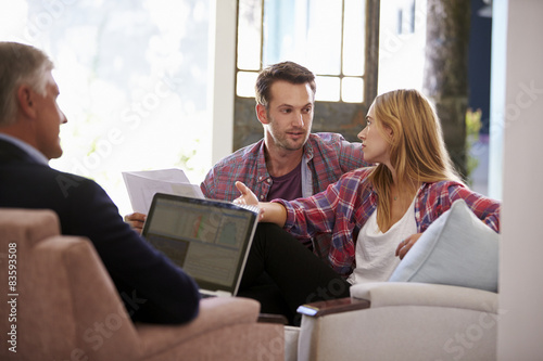 Couple At Home Meeting With Financial Advisor