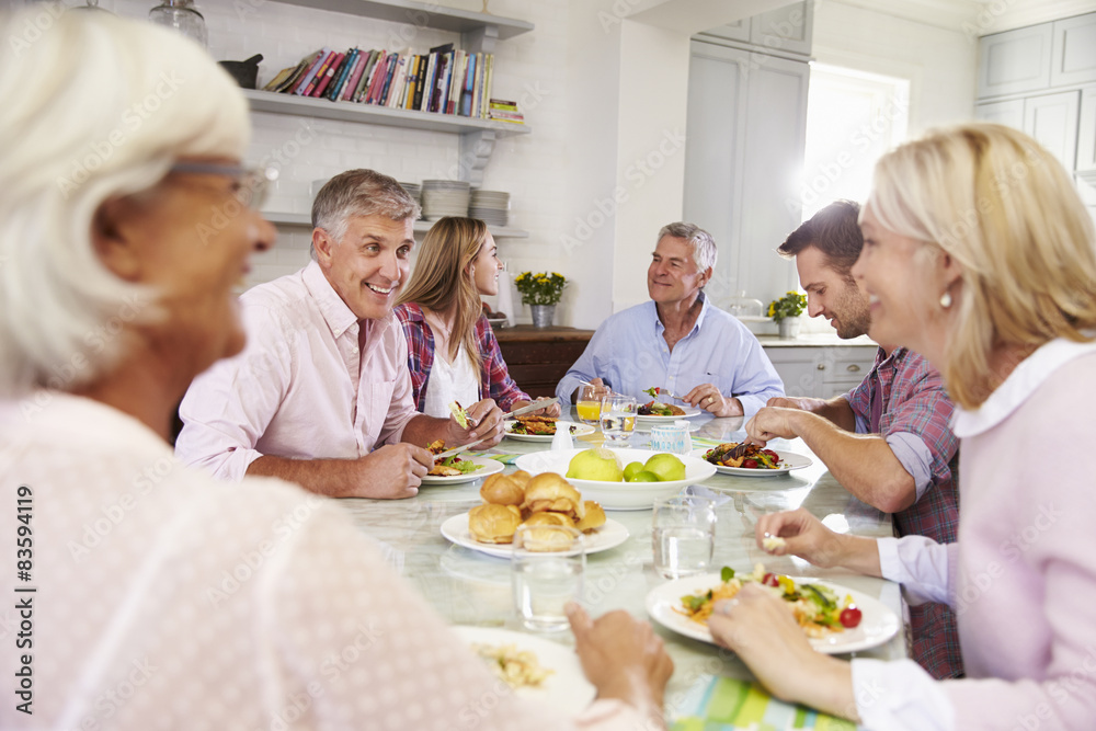 Group Of Friends Enjoying Meal At Home Together