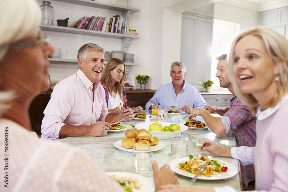 Group Of Friends Enjoying Meal At Home Together