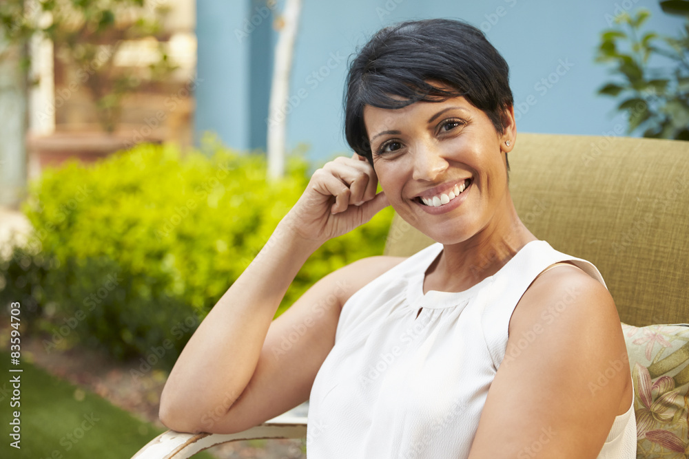 Portrait Of Mature Woman Relaxing Outdoors In Garden Portrait Of Mature Woman Relaxing Outdoors In Garden
