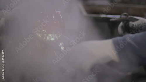 Shaping A Rotating Glass piece With Special Tongs 
