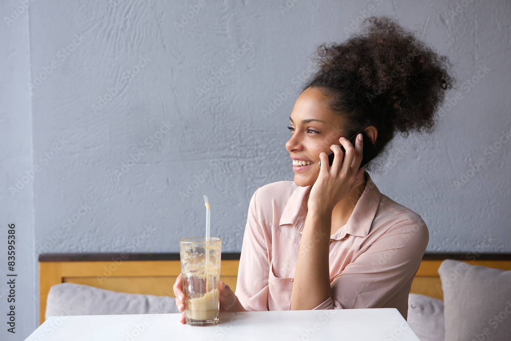 Woman sitting at restaurant talking on mobile phone Woman sitting at restaurant talking on mobile phone