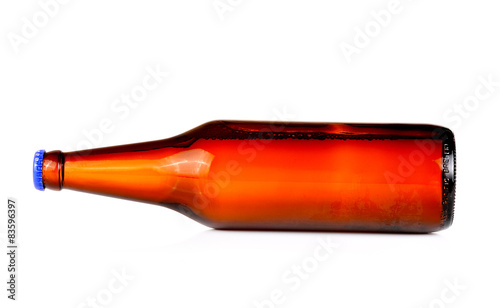 Bottle of beer with drops isolated on white background