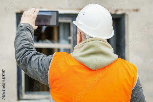 Construction inspector with tablet PC near building © Stock Photos & Video