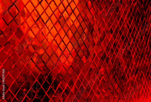 Orange and red rectangular table with a glass surface.