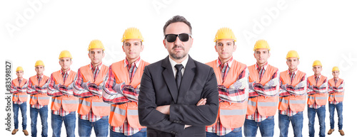 Executive manager with team of builders behind