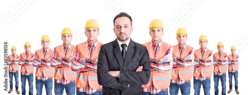 Confindent business man and a team of construction workers