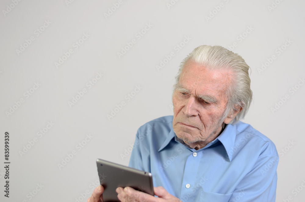 Älterer Mann hält einen modernen Tablet-PC Älterer Mann hält einen modernen Tablet-PC
