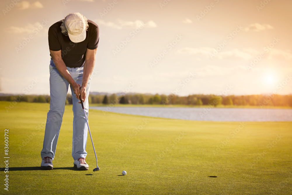 Fototapeta premium Senior golf player on green with copyspace.