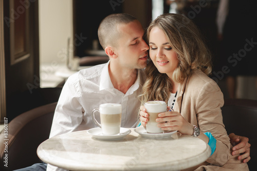 Happy couple drinking coffee in a local cafe.