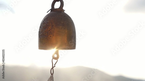 Thai Bell Hang in Temple against Sunset. Slow Motion. photo