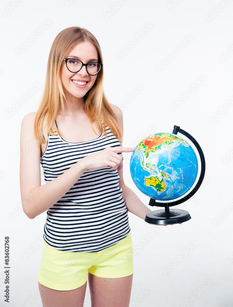 Happy young girl pointing finger on world globe Happy young girl pointing finger on world globe