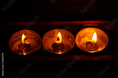 Burning candles on dark background with warm light