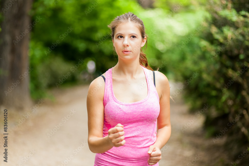 Young woman doing jogging in a park Young woman doing jogging in a park