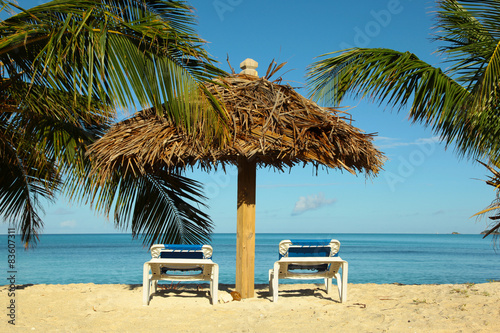 beach palm umbrella with two chairs
