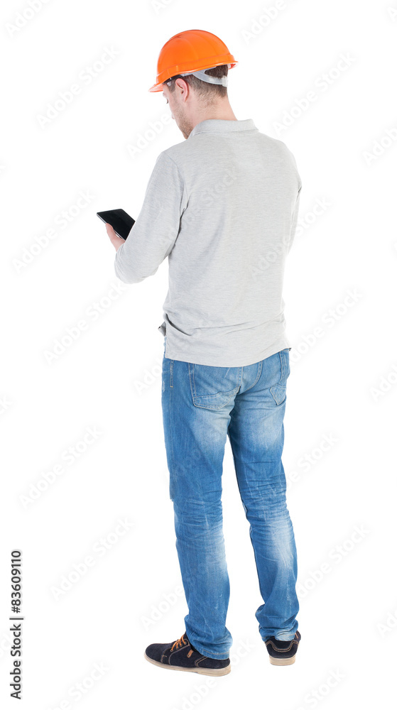 young engineer in a protective helmet with tablet computer in th young engineer in a protective helmet with tablet computer in th