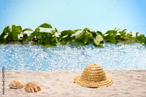 Relaxation at the beach with sunhat and shells 