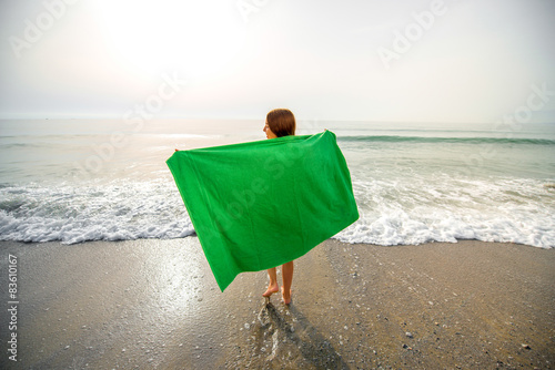 Photos Woman in green towel on the beach