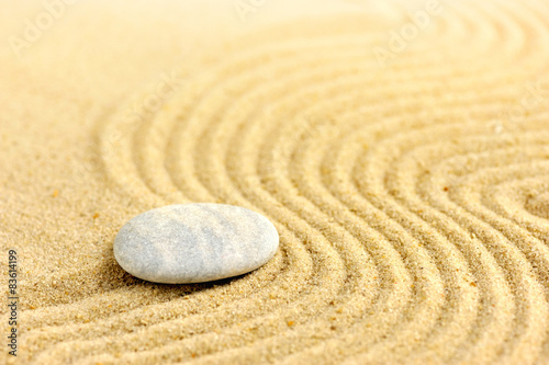 Zen stone at of sand background