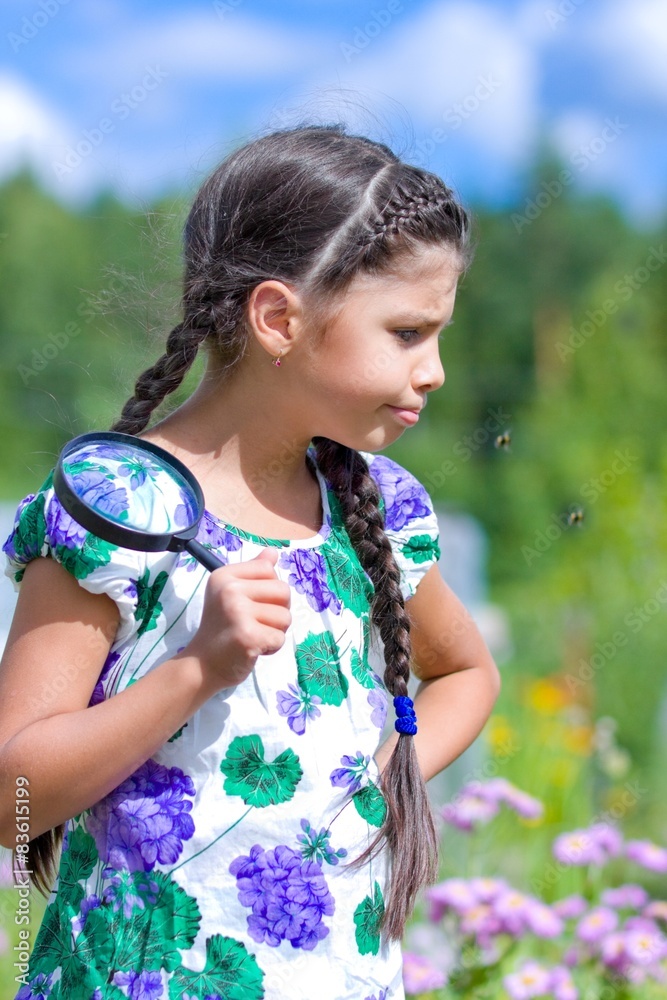 Unhappy girl with magnifying glass in summer Unhappy girl with magnifying glass in summer