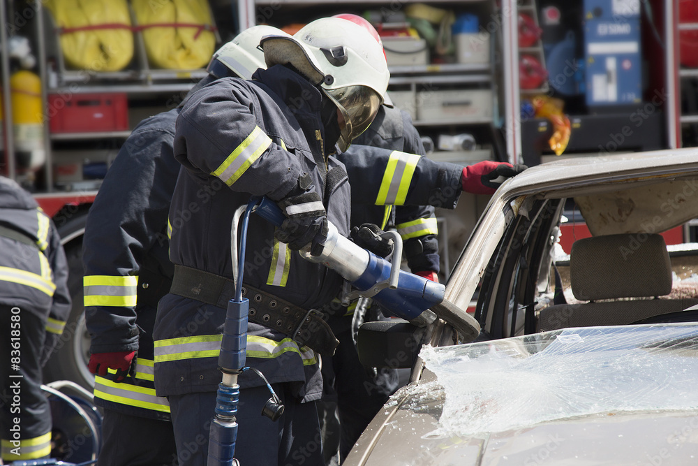 firefighters with the pneumatic shears open the car doors firefighters with the pneumatic shears open the car doors