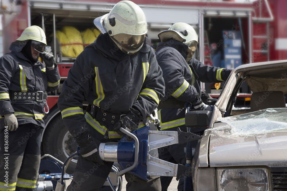 firefighters with the pneumatic shears open the car doors firefighters with the pneumatic shears open the car doors
