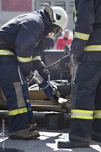 firefighters with the pneumatic shears open the car doors