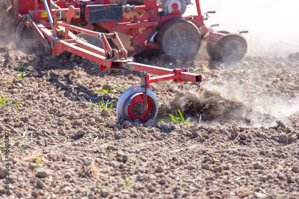 Tractor harrowing the field Tractor harrowing the field