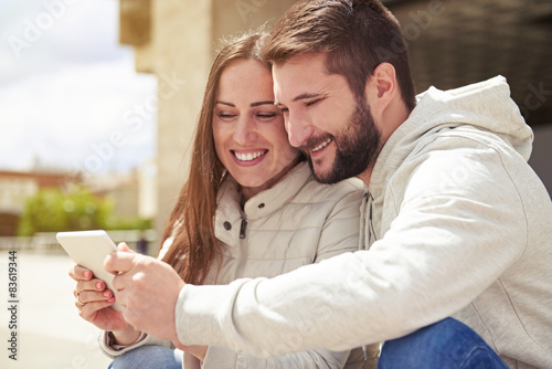 couple in love looking at tablet pc