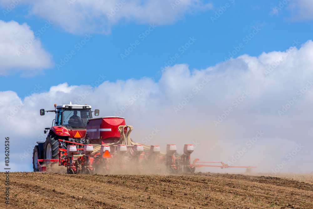 Obraz premium Tractor harrowing the field