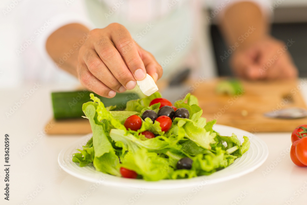 man preparing green salad