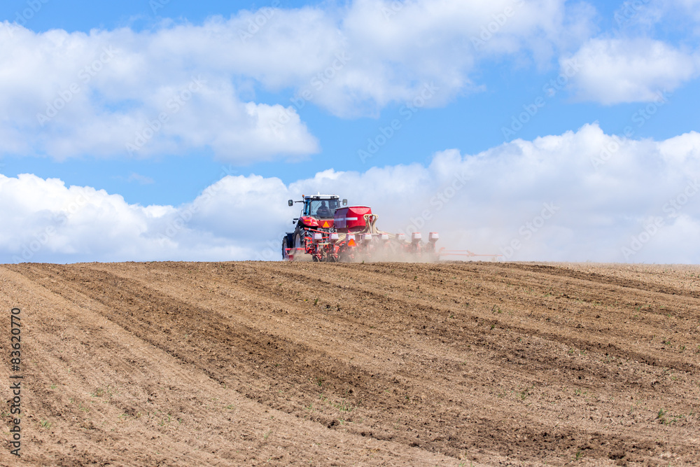 Tractor harrowing the field