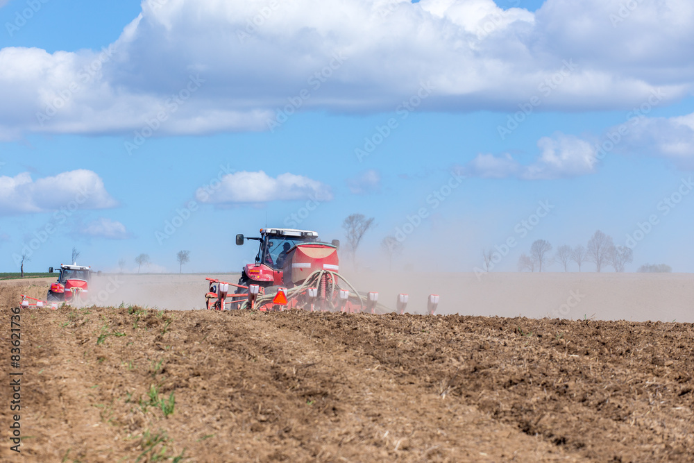 Fototapeta premium Tractor harrowing the field
