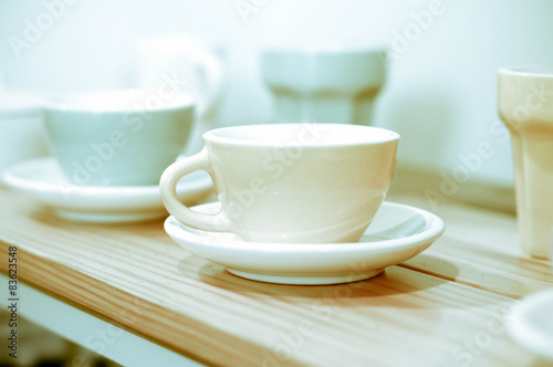 Coffee cup on wooden shelf