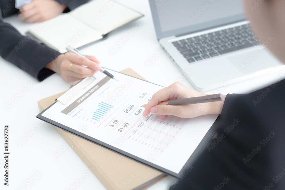 Business people discussing the charts and graphs showing the res Business people discussing the charts and graphs showing the res
