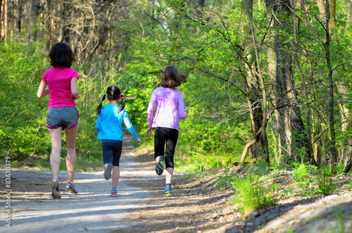 Fototapeta Naklejka Na Ścianę i Meble -  Family sport, mother and kids jogging, running in forest
