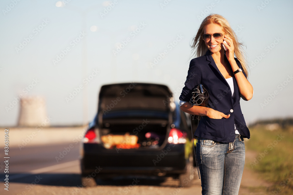 Fashion woman next to broken car calling on cell phone Fashion woman next to broken car calling on cell phone