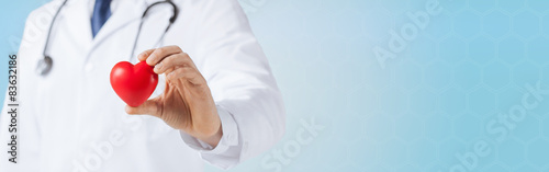 close up of male doctor hand holding red heart photo
