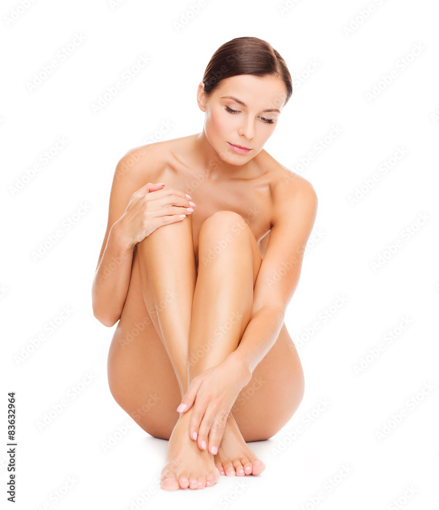 beautiful naked woman touching her legs beautiful naked woman touching her legs