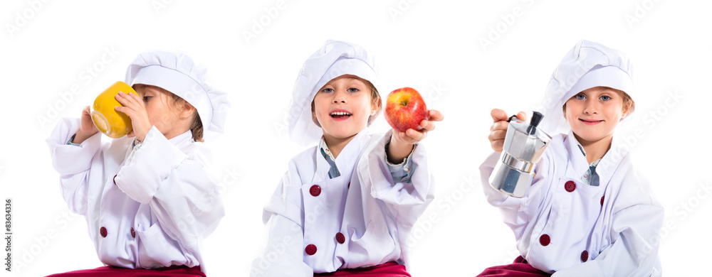 Blonde little girl dressed like chef holding coffee pot Blonde little girl dressed like chef holding coffee pot