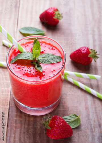 Strawberry smoothie on the wooden table