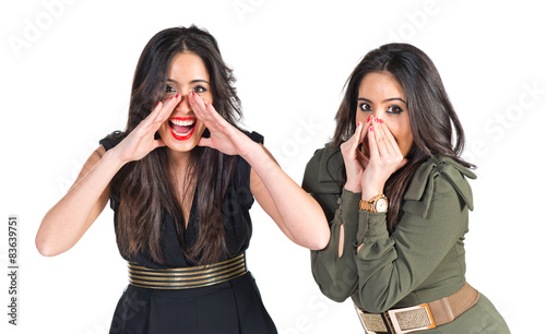 Sisters shouting over white background