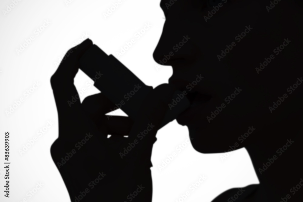 Composite image of blonde woman taking her inhaler
