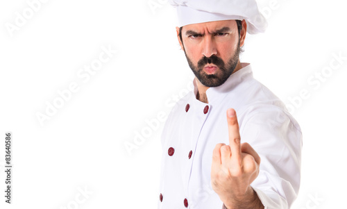 Chef making horn gesture over white background