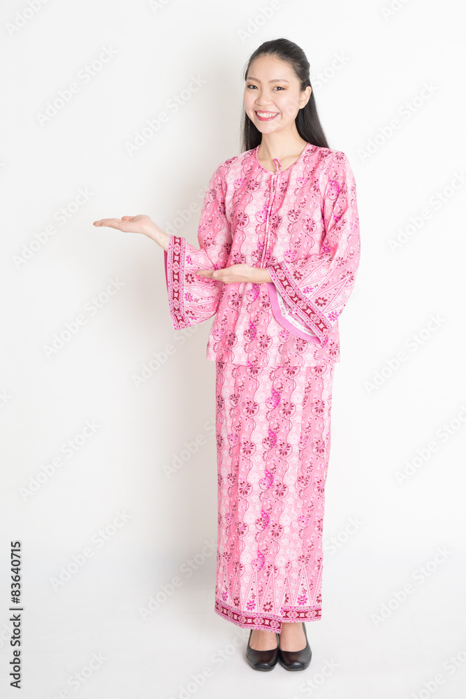 Asian girl in pink batik dress showing somethings Asian girl in pink batik dress showing somethings
