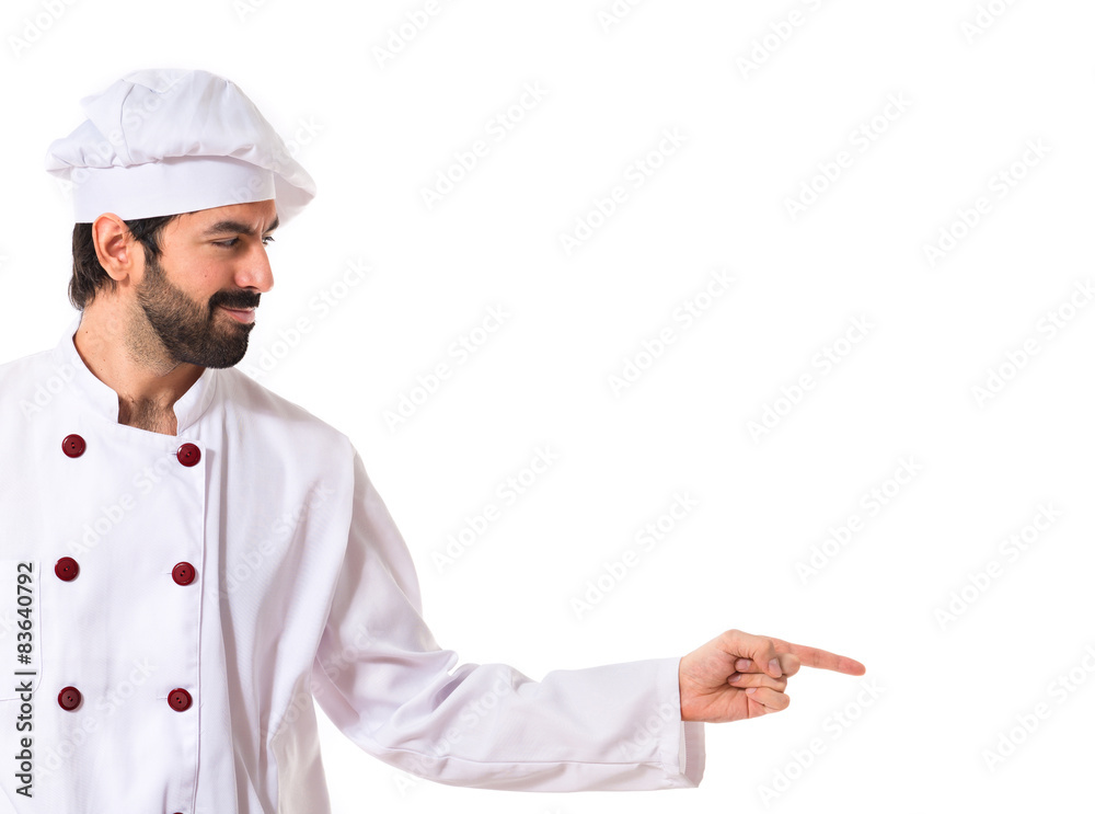 Chef pointing to the lateral over white background Chef pointing to the lateral over white background