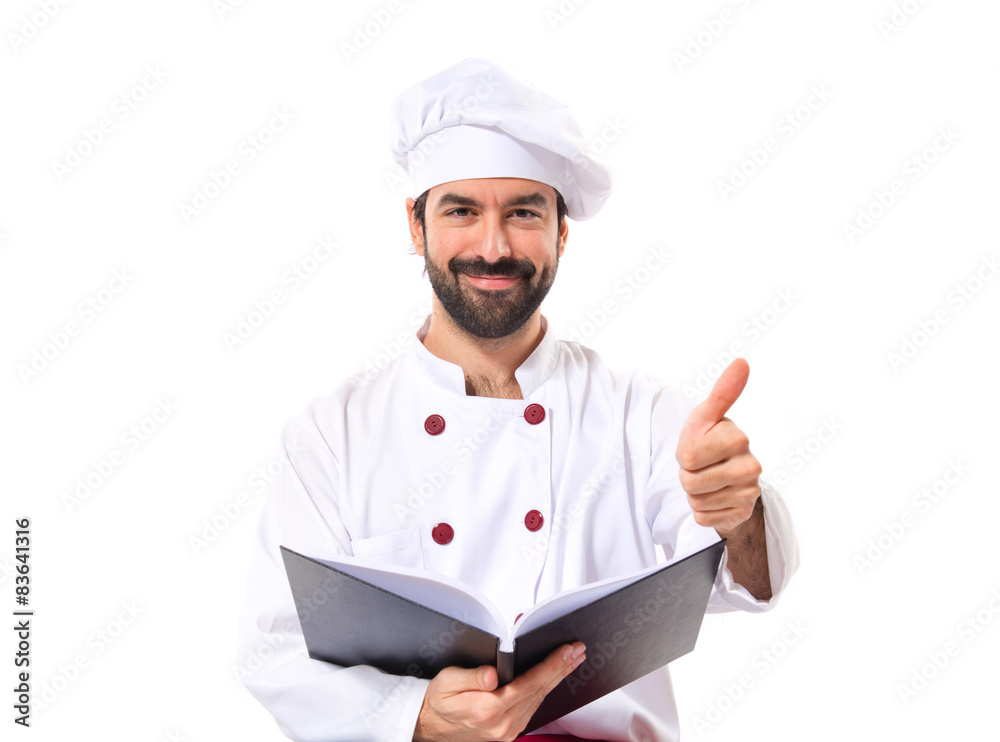 Happy chef reading a book