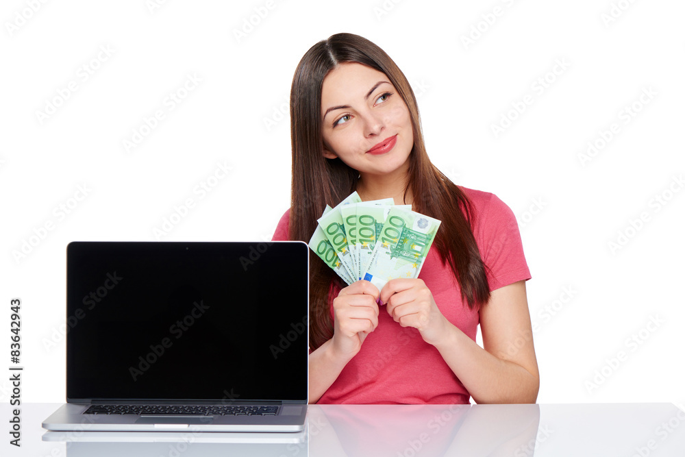 Woman with euro cash showing blank laptop screen Woman with euro cash showing blank laptop screen