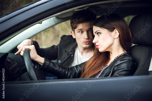 couple quarrel in the car,  woman behind wheel of  car