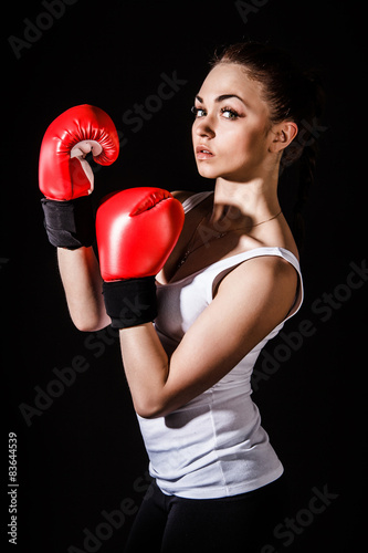 Beautiful young woman in a red boxing gloves